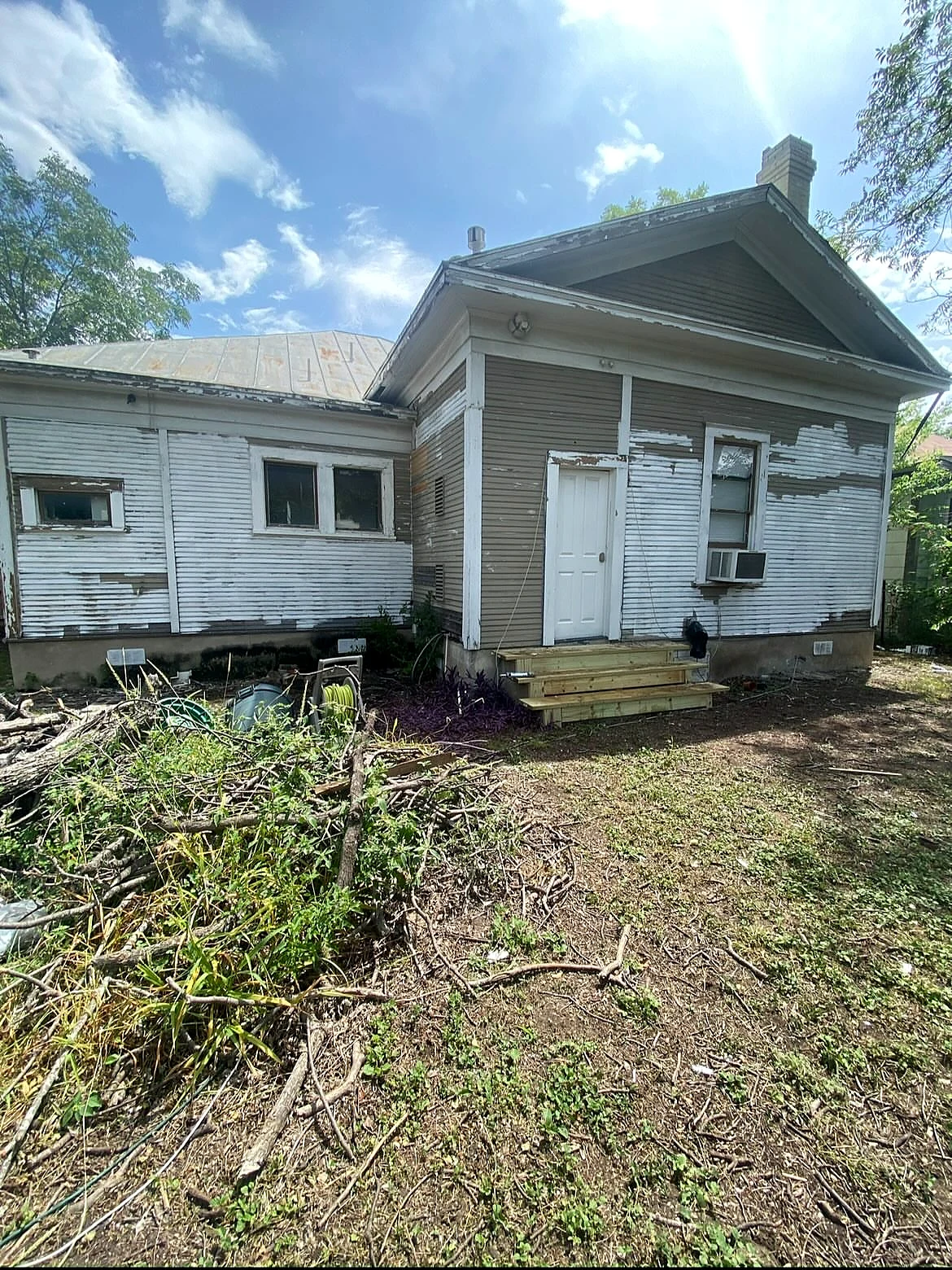 Weathered exterior before siding repair and painting
