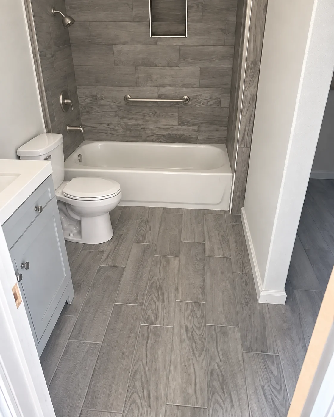 Finished tiled tub and shower with safety grab bar