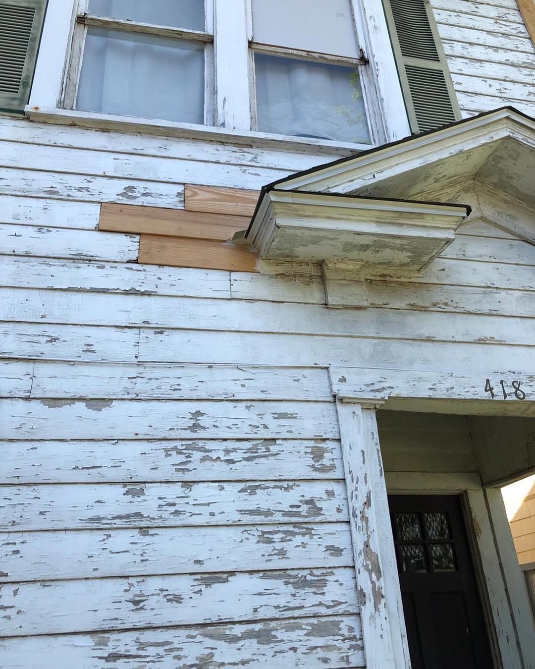 Peeling blue exterior before siding and trim restoration