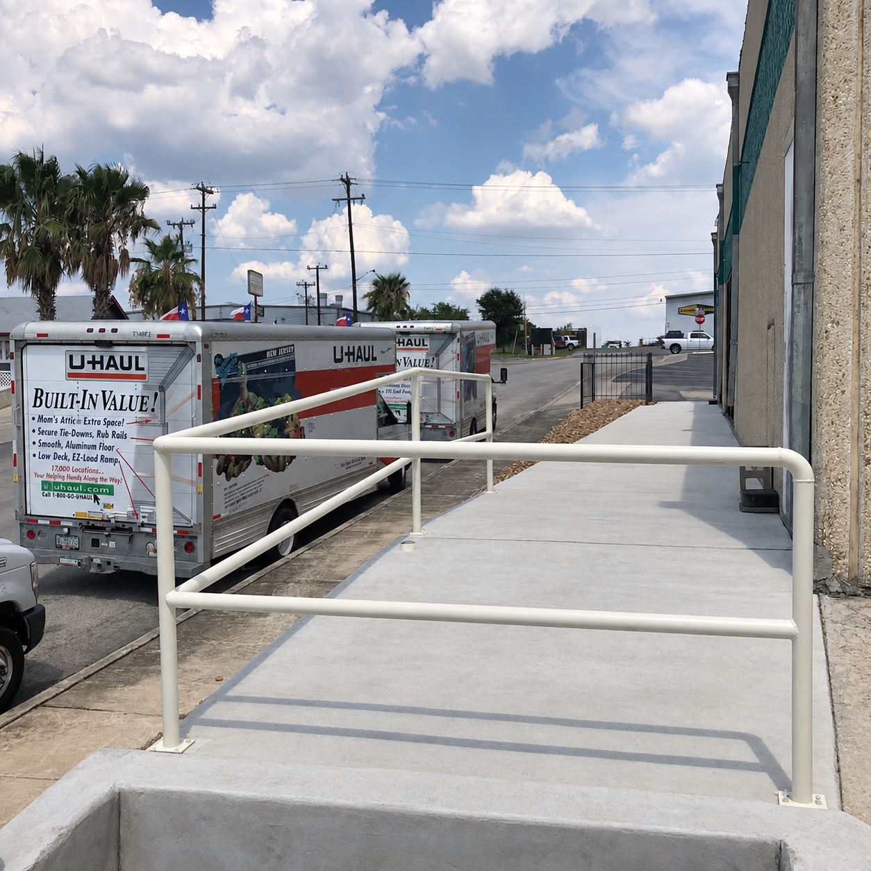 Completed concrete landing with fitted metal safety handrail