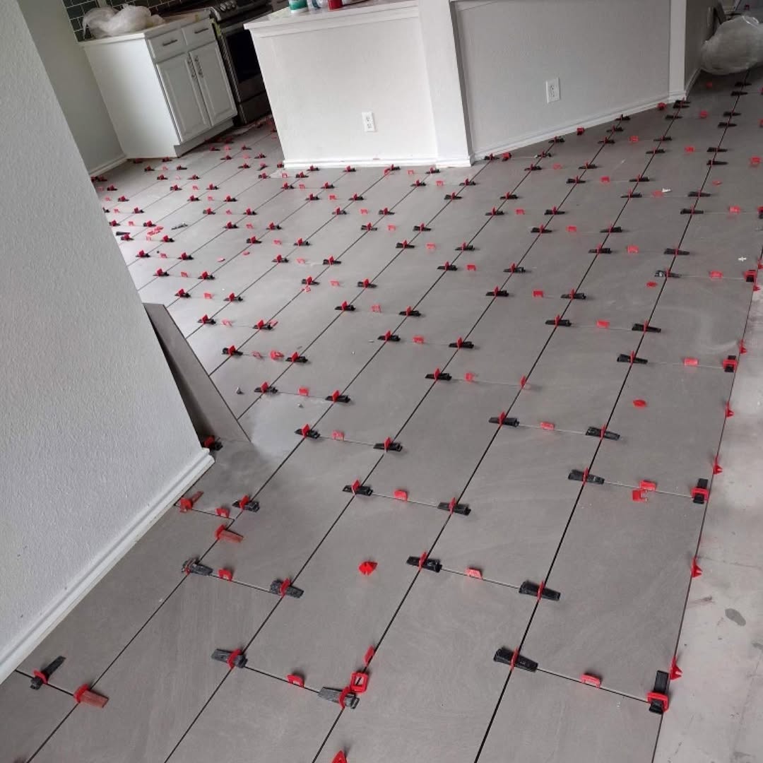 Large-format kitchen floor tile during installation
